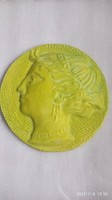 Wall decoration with a Greek head, golden green relief, plaster embossed image, wall decoration