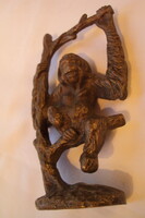 Figure of a monkey sitting on a brass branch, with characteristic processing. (Casting)