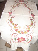 Beautiful hand-embroidered floral tablecloth runner with a lace edge