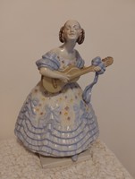 A large porcelain statue of Mrs. Déryn in a blue dress from Herend