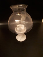 A kerosene lamp holder with a candle on a marble base