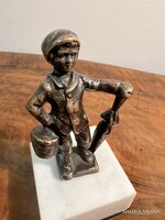 Bronze boy with umbrella on a marble base