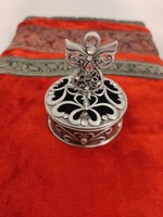 Openwork lace patterned metal box with an angel standing on the lid