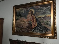 A large, religious-themed picture, made with Gobelin technique, in a gilded frame.