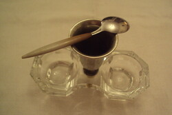 A pair of spice holders (salt holders) made of cast glass, with a silver-plated spoon holder in the middle and a spoon with a small bone handle.