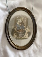 Saint image in an oval copper frame.