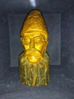 A peasant man, carved from wood, wearing a large folk hat. Wooden sculpture!