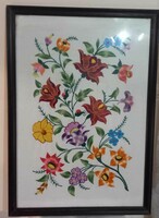 Hand-embroidered wall picture in a wooden frame.