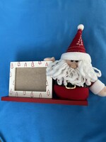 Santa Claus, with a wooden photo frame on a stand