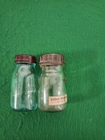 Two old medicine bottles with vinyl caps for sale.