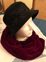 Elegant black women's hat and red velvet scarf