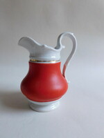 Antique red milk jug