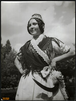 Larger size, photo art work by István Szendrő. A girl in folk costume, mite, fierce