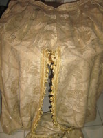 Beautiful vintage antique gold color baroque patterned drapery silk brocade curtain with gold fringe in the middle