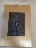 Bronze relief by István Adorján on a wooden plate