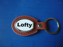 Lofty oval metal key ring on a leather base