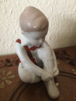 Little boy pulling shoes - Aquincum porcelain statue