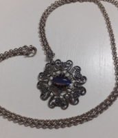 An industrial long silver-plated chain with an openwork pattern pendant with a set stone in the middle