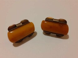 A large perhaps alpaca cufflink decorated with amber