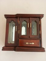 A small cabinet for jewelery is made of wood
