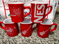 Red coffee mugs with Nescafé inscription