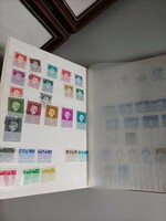 Medium-sized stamp collecting album in good condition with a few stamps
