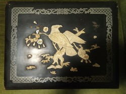 A very old photo album with a decorative lacquered wood cover