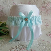 White lacy, turquoise colored bridal garter with rhinestones, thigh lace
