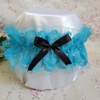Turquoise lace bridal garter with black bow, thigh lace