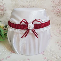 Snow-white lace, burgundy bow-flower bridal garter, thigh lace
