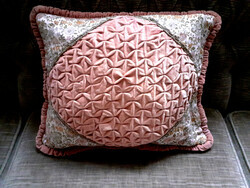 Old ruffled decorative pillow with filling.
