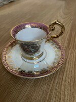 A dreamy collector's chandelier with a glazed, scenic mocha cup and plate.