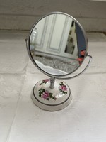 One side of the vanity mirror with a fairy porcelain base has a magnifying glass.