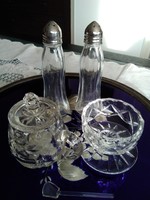 Stylish glass spice holders together on the laid table.