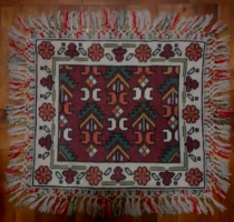 Old beautiful hand-made tapestry table cloth with a fringe on the edge