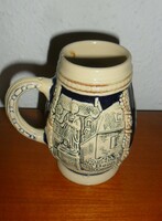 Beer mug with German embossed pattern. 11 cm high.