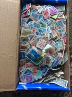 Many thousands of stamps in bulk in boxes