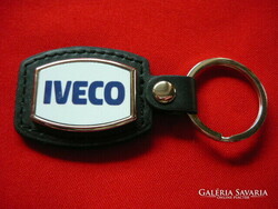 Iveco metal keychain on a leather background