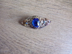 Copper brooch with polished blue stone
