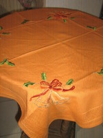 Wonderful Christmas bell with hand embroidered orange tablecloth