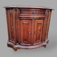 Arched chest of drawers with root veneer