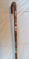Antique hiking stick with badge and stick label