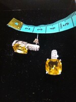 Silver earrings with a shiny yellow stone