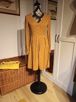 Orsay women's dress with a pattern on a yellow background