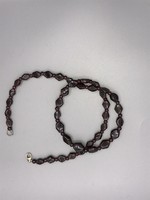 Necklace made of dark burgundy garnet stones polished to a beautiful shape