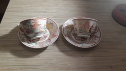 2 antique oriental-patterned faience tea cups with a small plate.