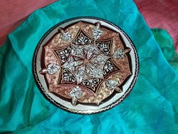 Red copper mandala plate.