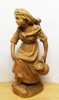 Antique carved statue. Girl with a jar of sandalwood wood