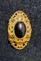 Antique fire-gilded brooch with onyx stone