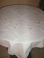 Beautiful pastel-toned spring floral white tablecloth